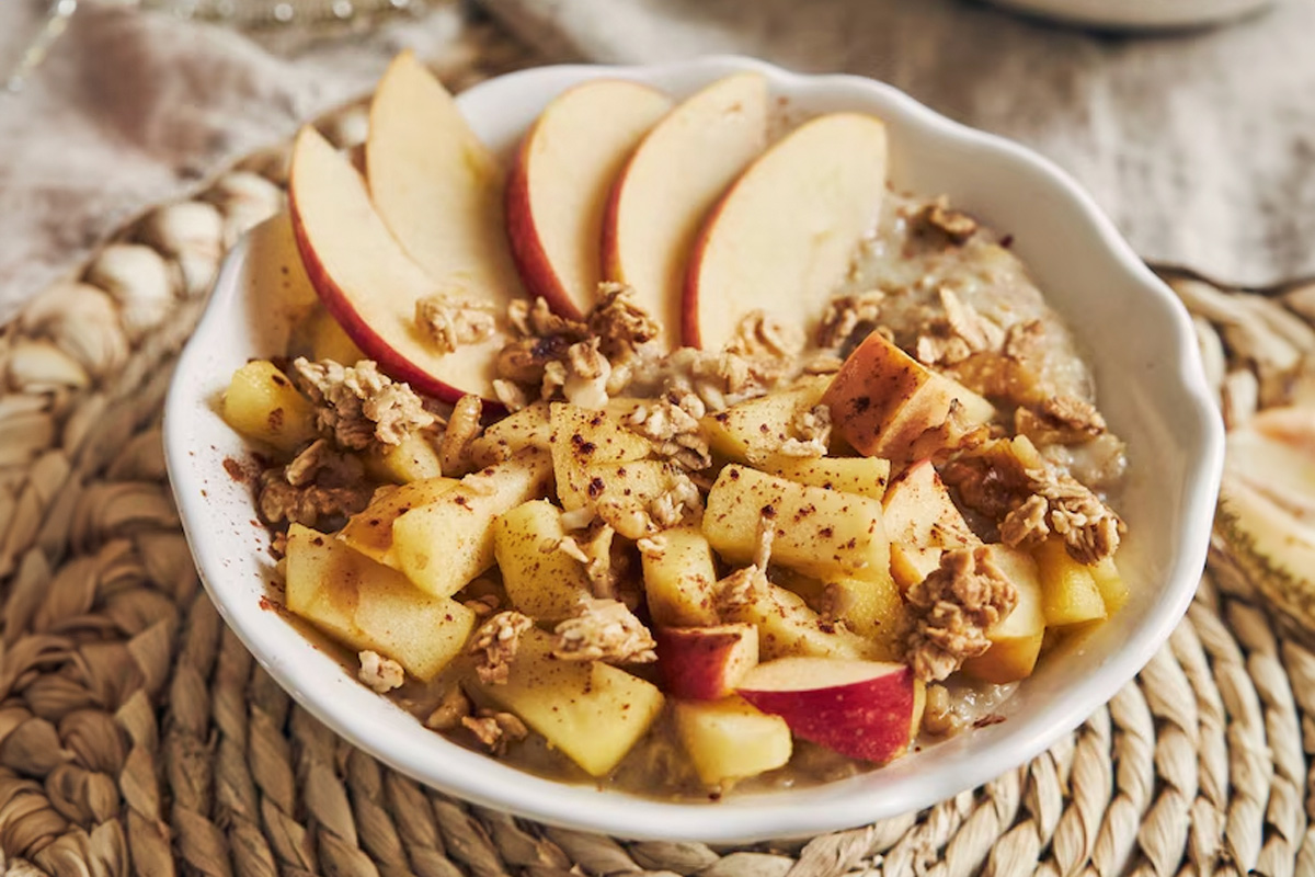 Oatmeal jar on kitchen table, bowl of oatmeal w/ fruits